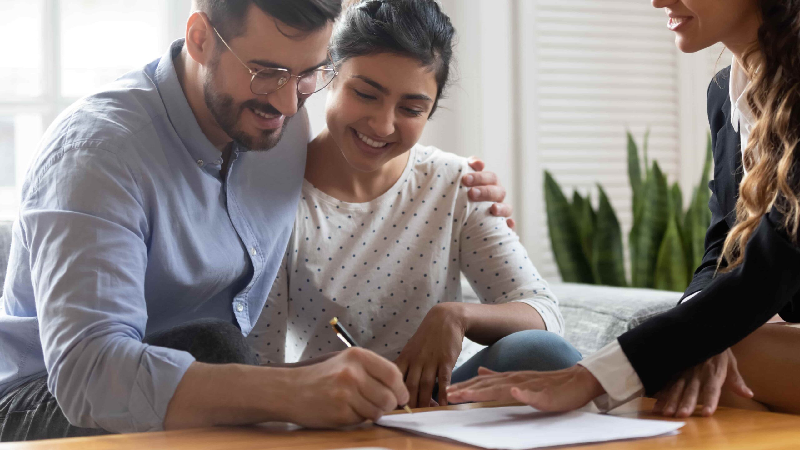 Couple signing house and land package